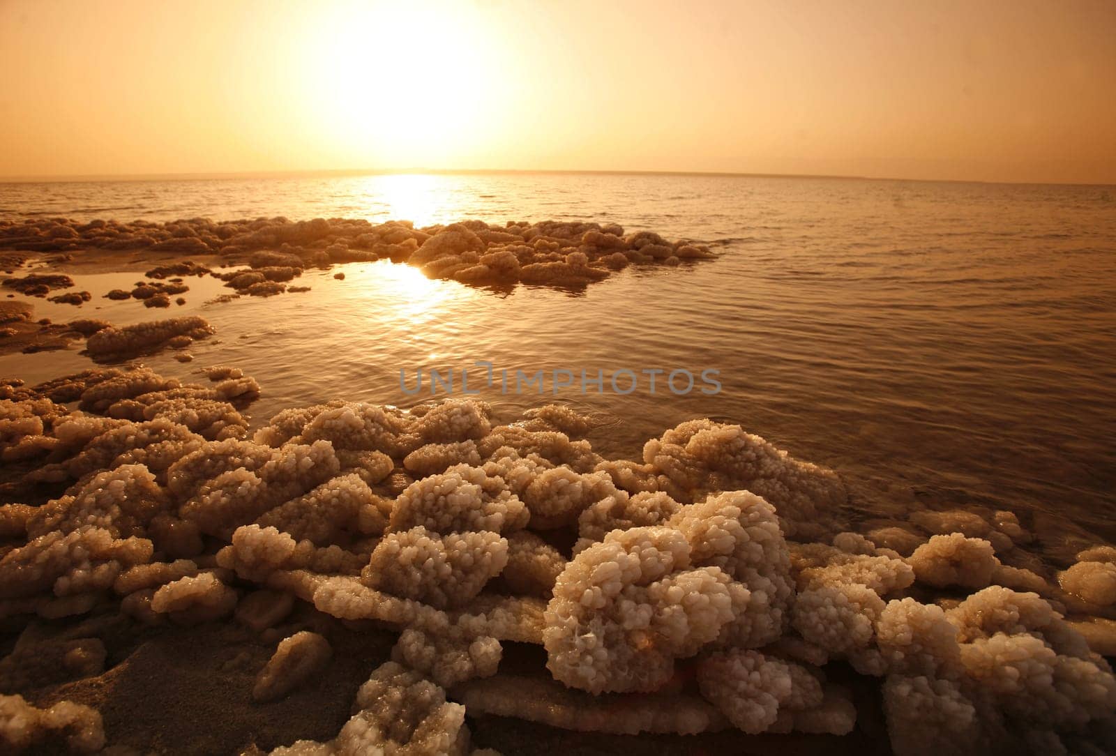 The coast with natural salt of the death sea neat the Village of Mazraa in Jordan in the middle east.