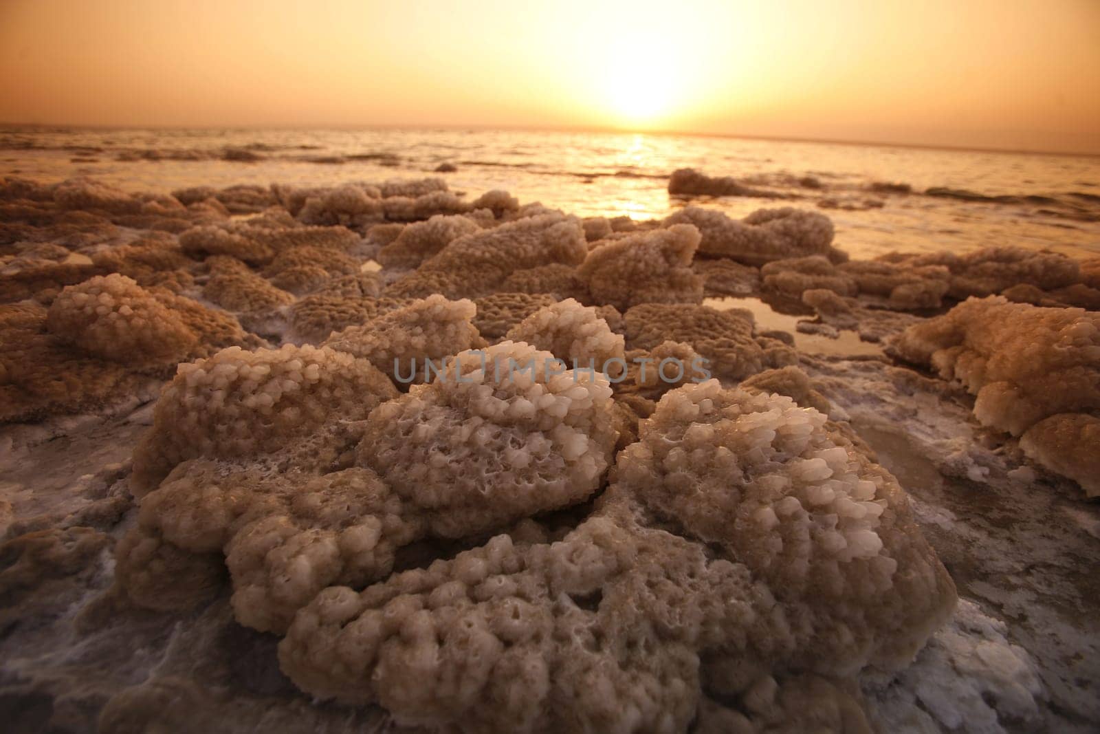 The coast with natural salt of the death sea neat the Village of Mazraa in Jordan in the middle east.