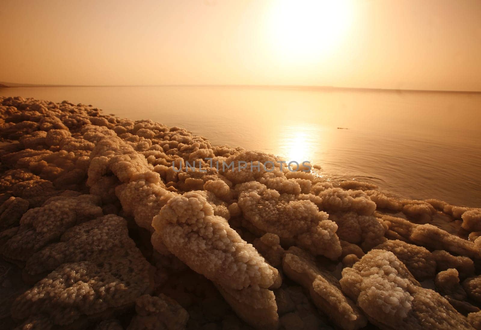 The coast with natural salt of the death sea neat the Village of Mazraa in Jordan in the middle east.
