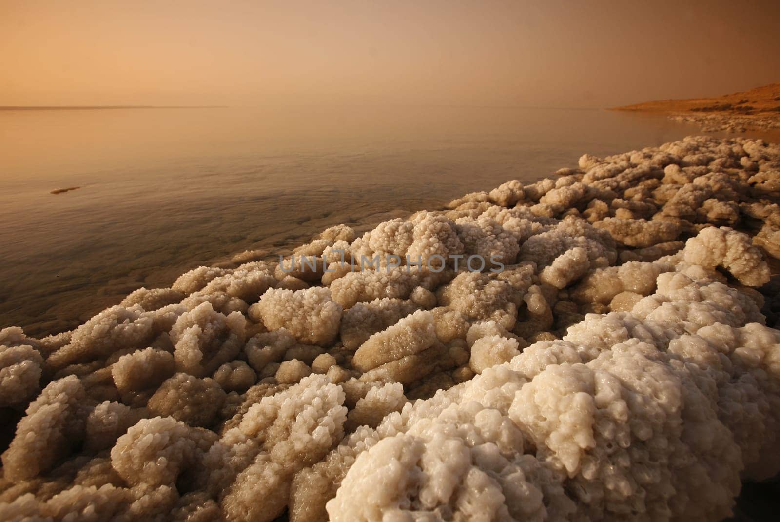 The coast with natural salt of the death sea neat the Village of Mazraa in Jordan in the middle east.