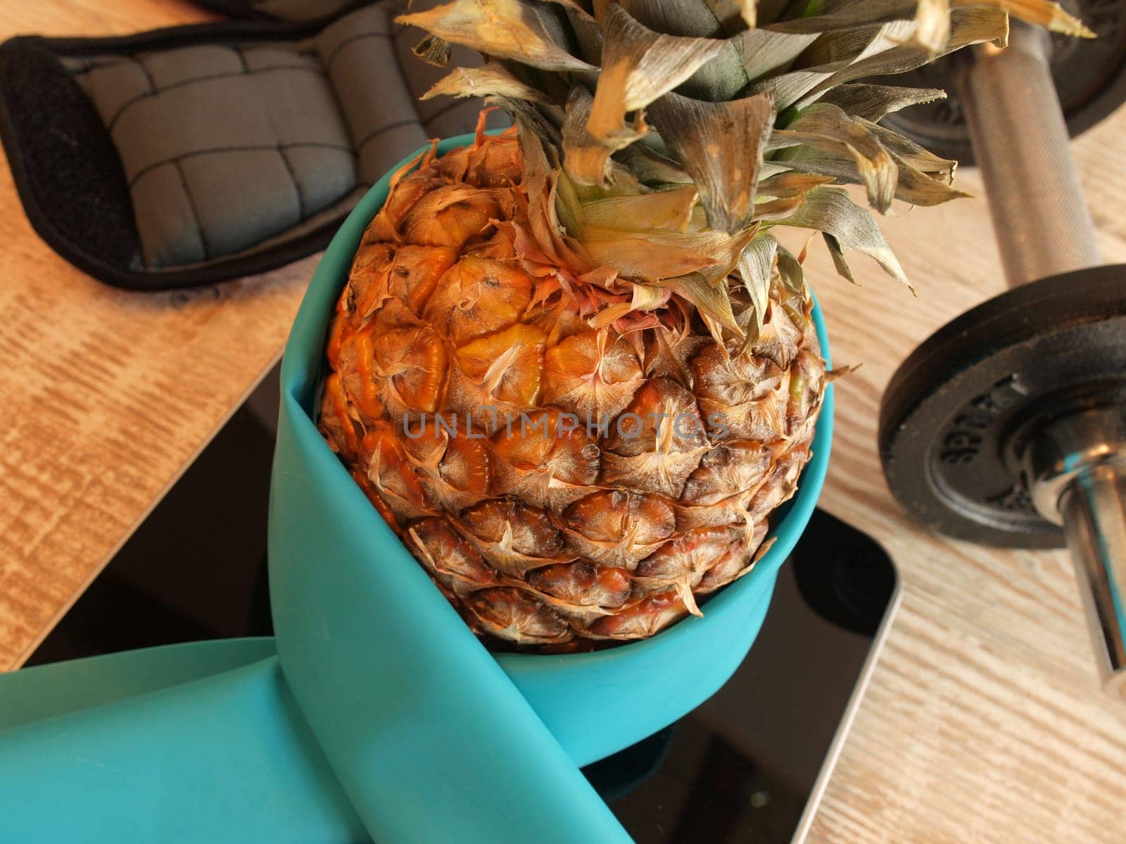 Fresh pine apple with sports equipment