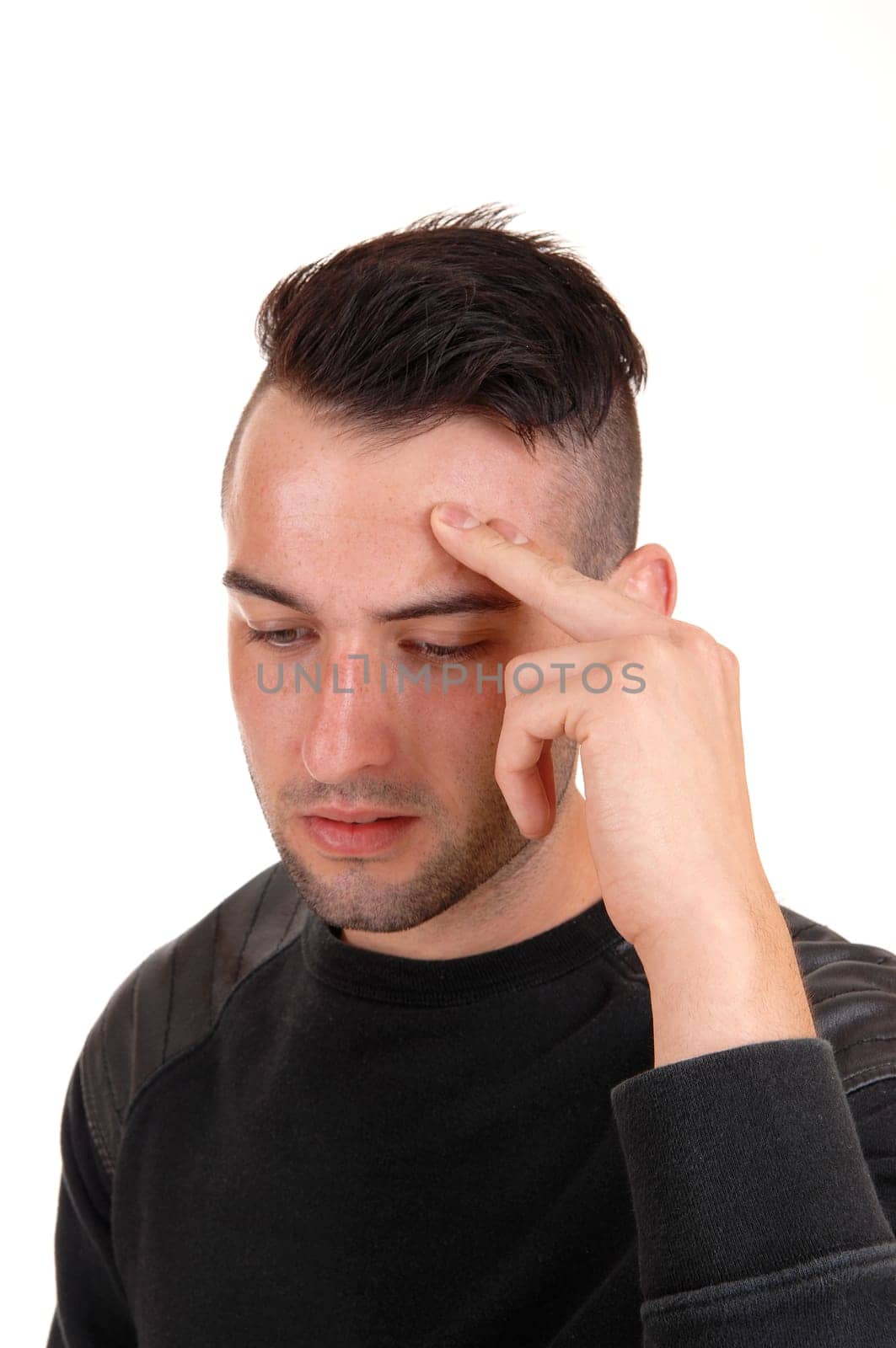 A young handsome man with his finger on his forehead and hard thinking,.isolated on white background..