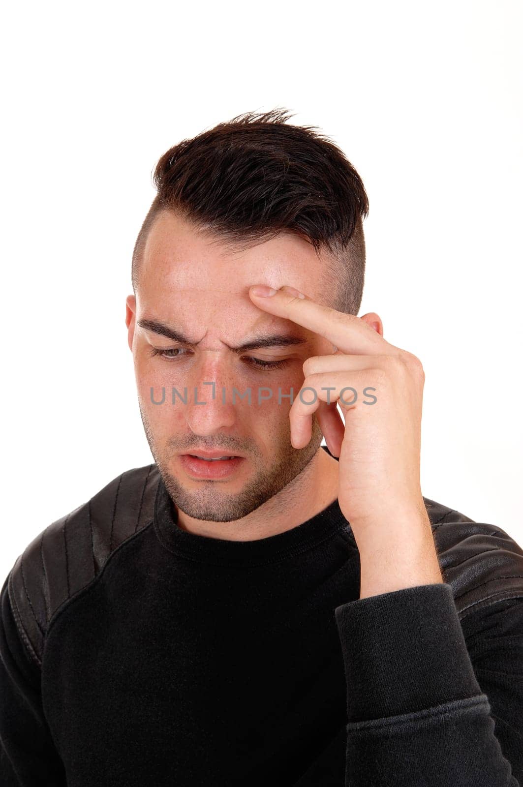 A young handsome man in a portrait with his finger on his forehead, .thinking hard, isolated on white background..