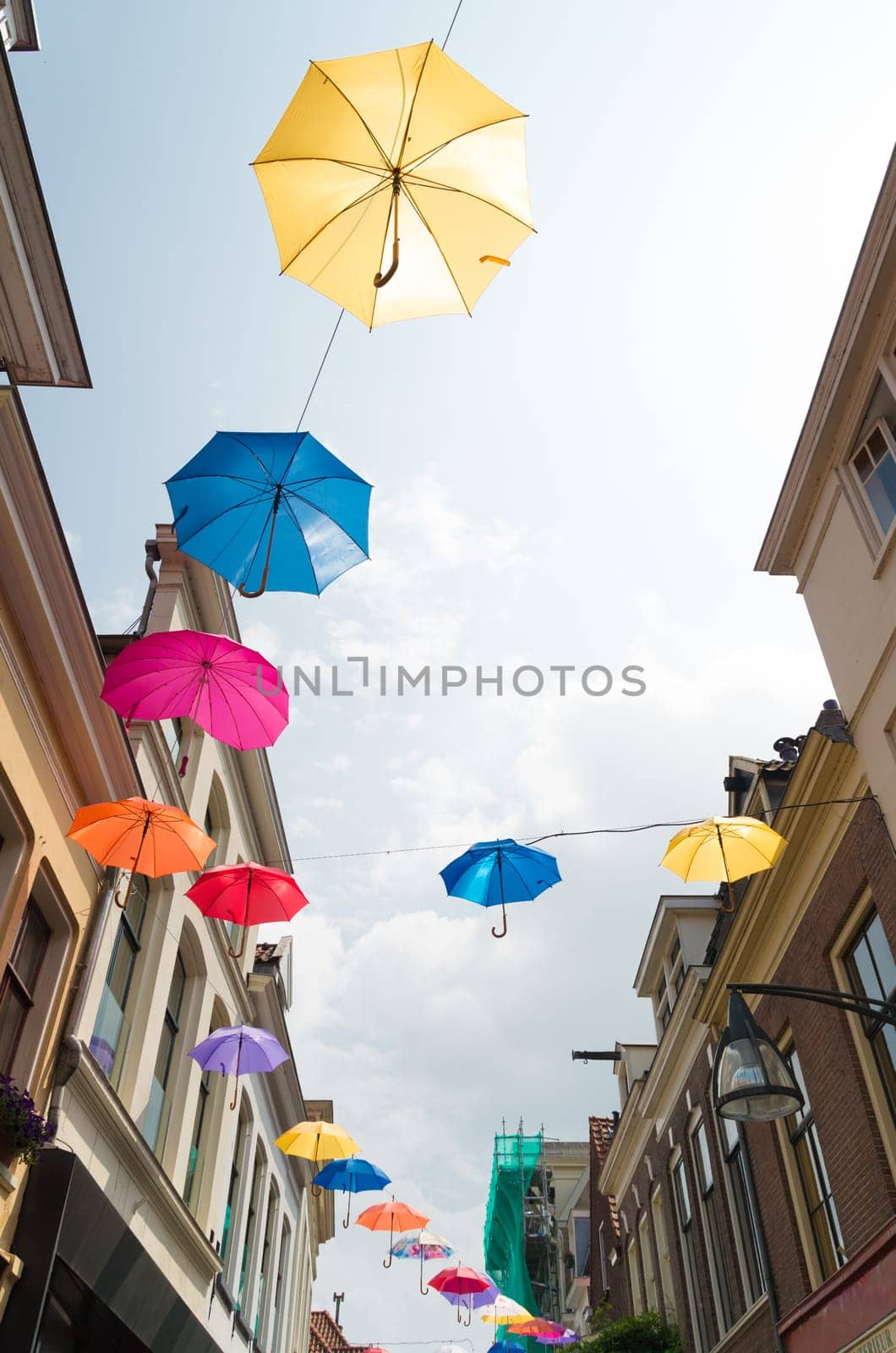 colorful umbrellas in the streets of Deventer, netherlands during "Deventer on stilts"", one of the most prestigious outdoor theatre festivals in the country"