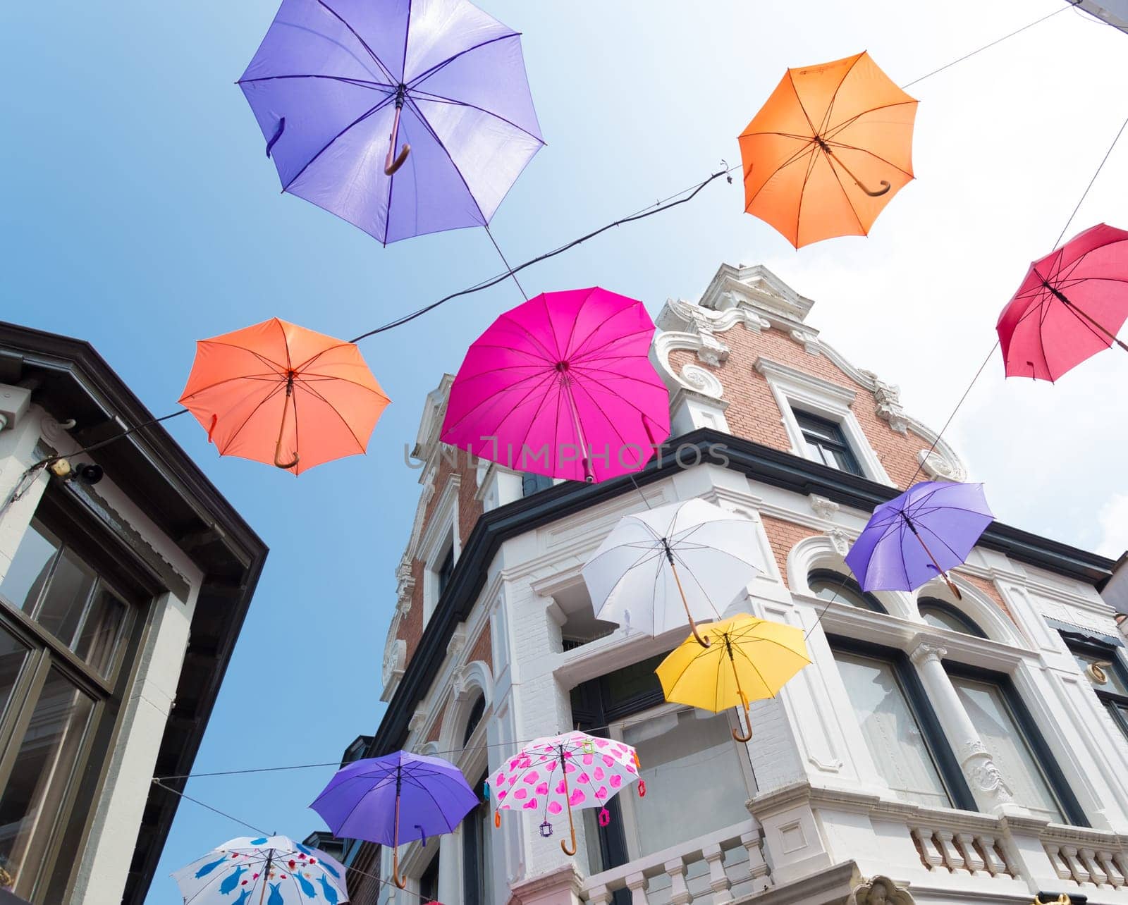 colorful umbrellas in the streets of Deventer, netherlands during "Deventer on stilts"", one of the most prestigious outdoor theatre festivals in the country"