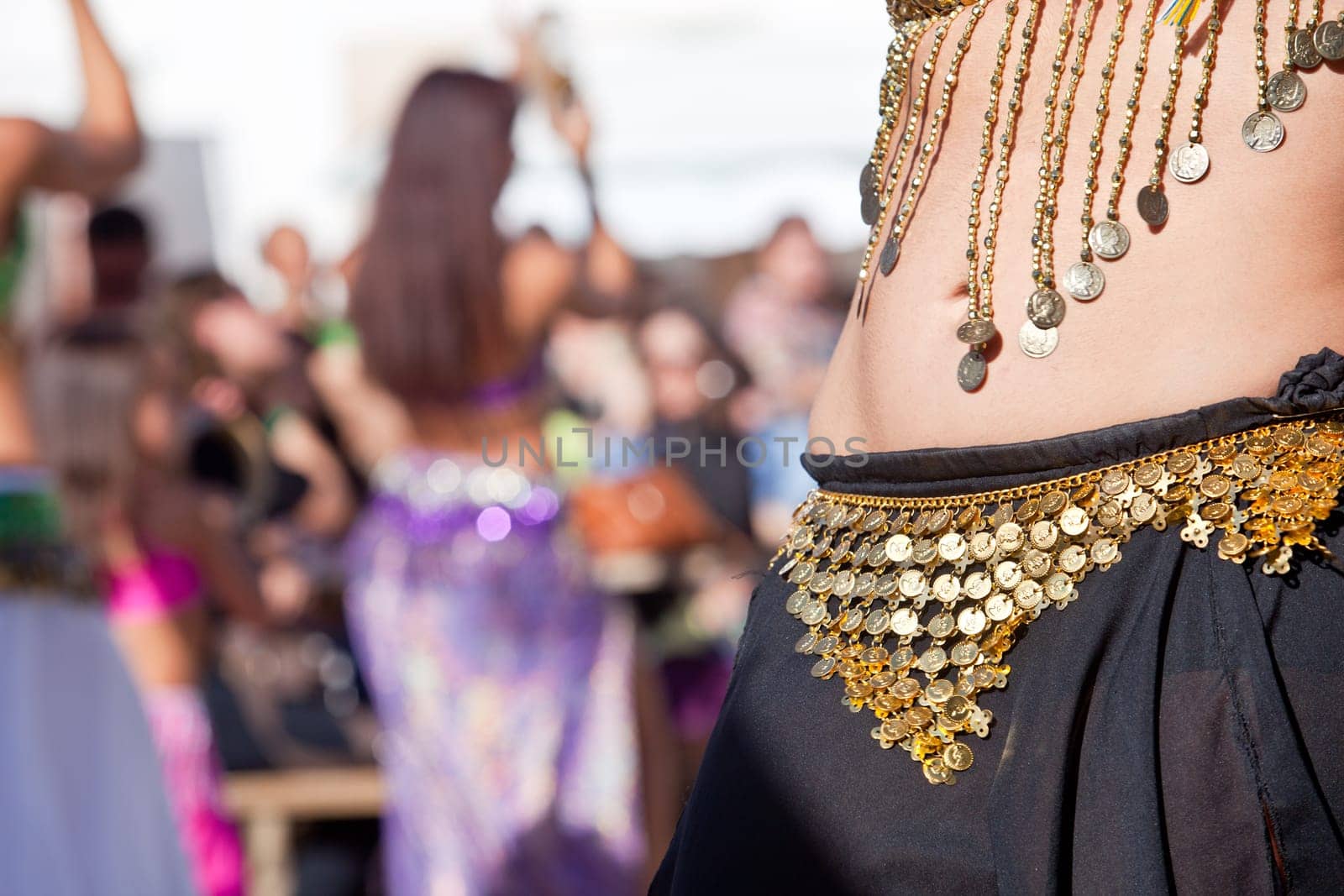 Belly dancers detail dancing with arabic music street band at the Almossasa Festival, Marvao, Portugal