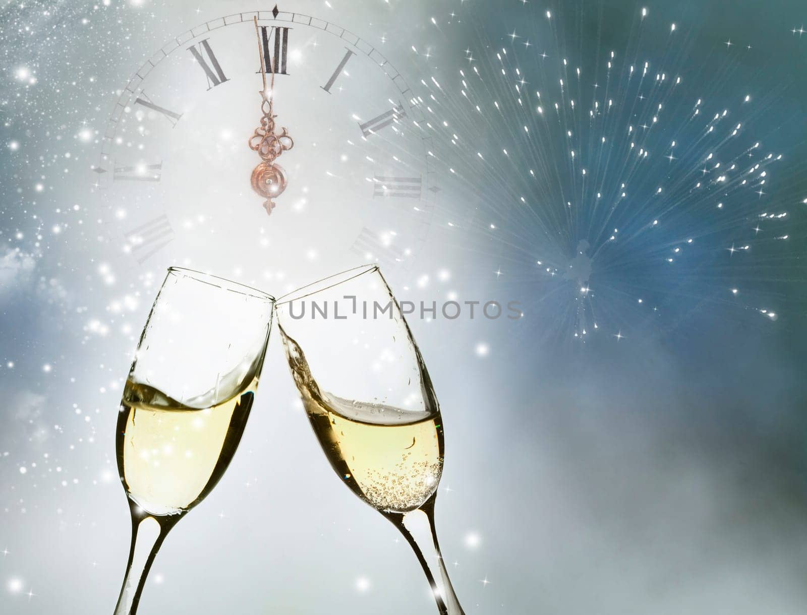 Glasses with champagne against holiday lights and clock close to midnight