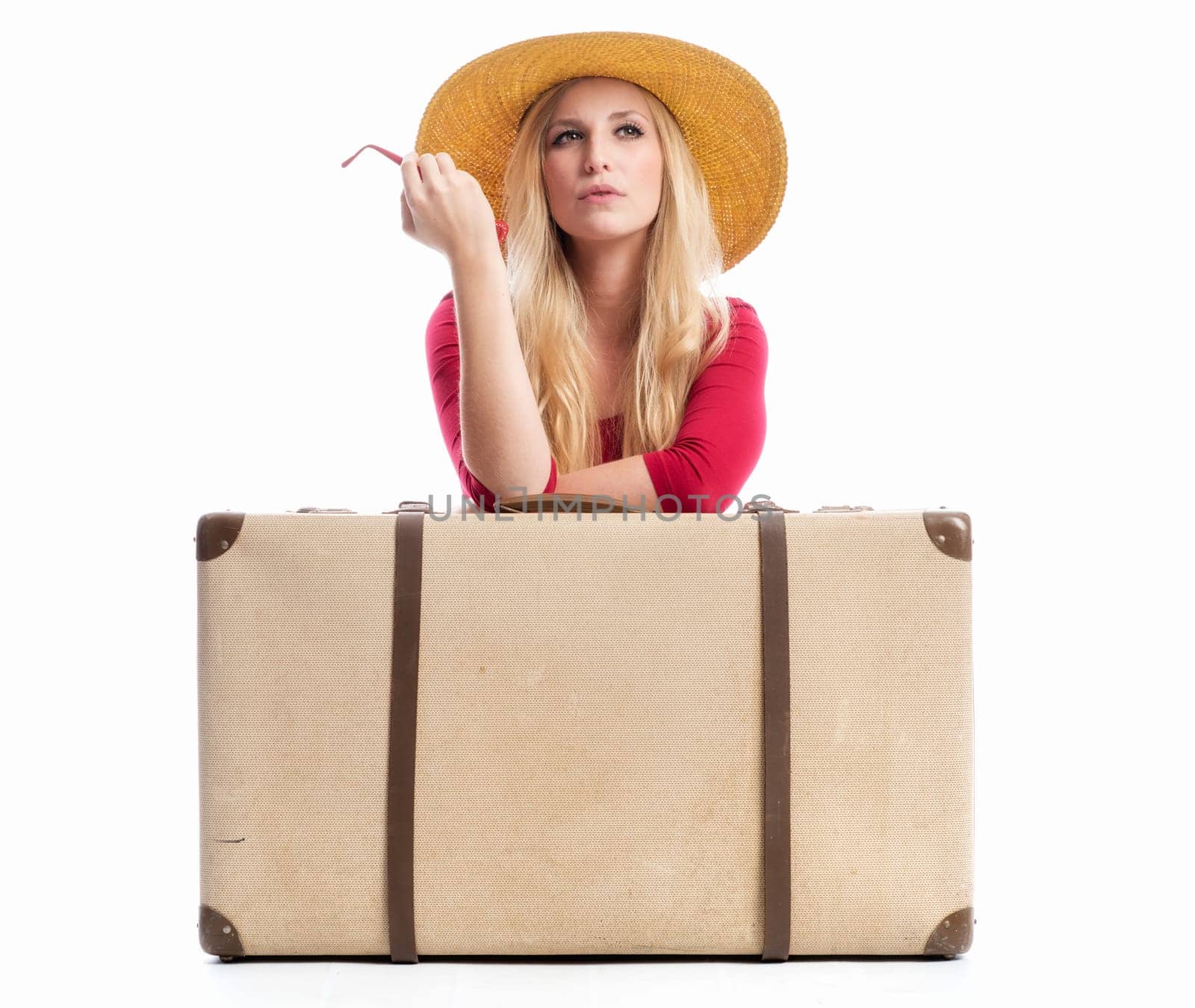an arrogant blonde woman sits behind a suitcase