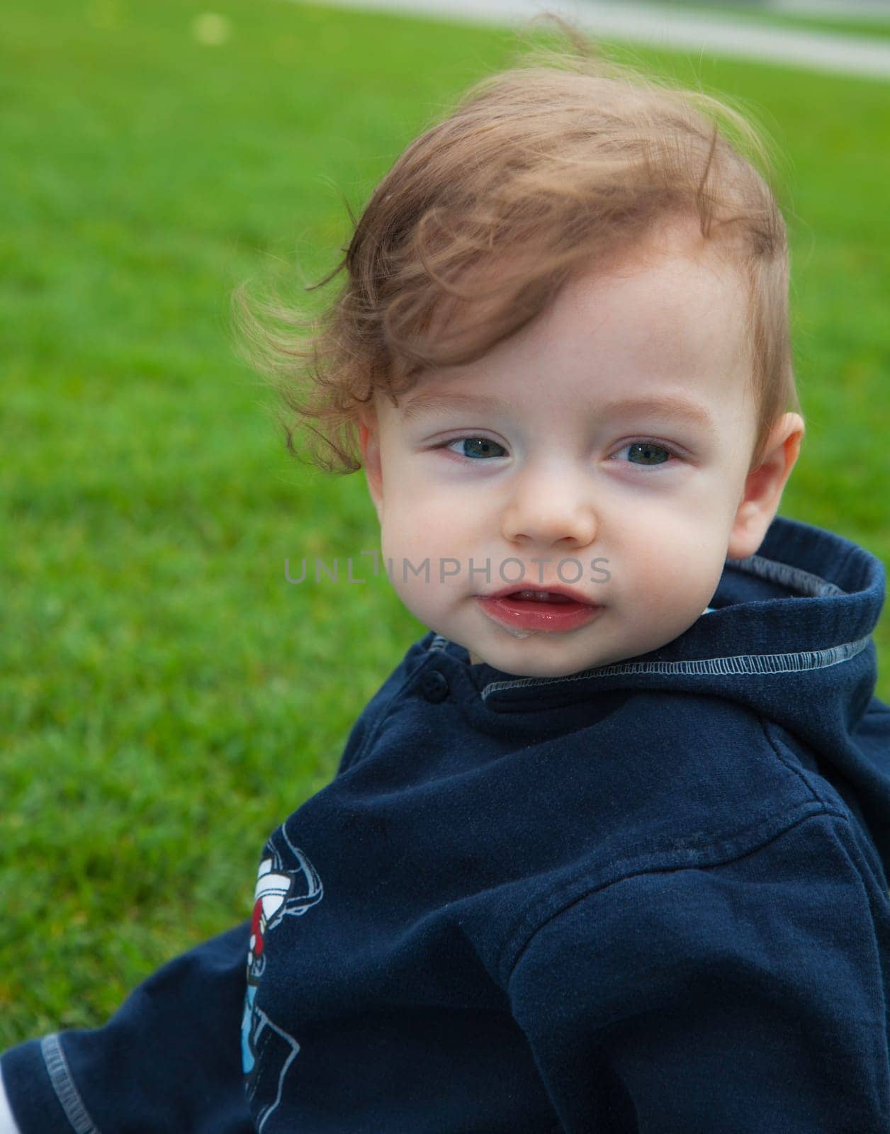 9 months old baby boy portrait outdoor in the park.