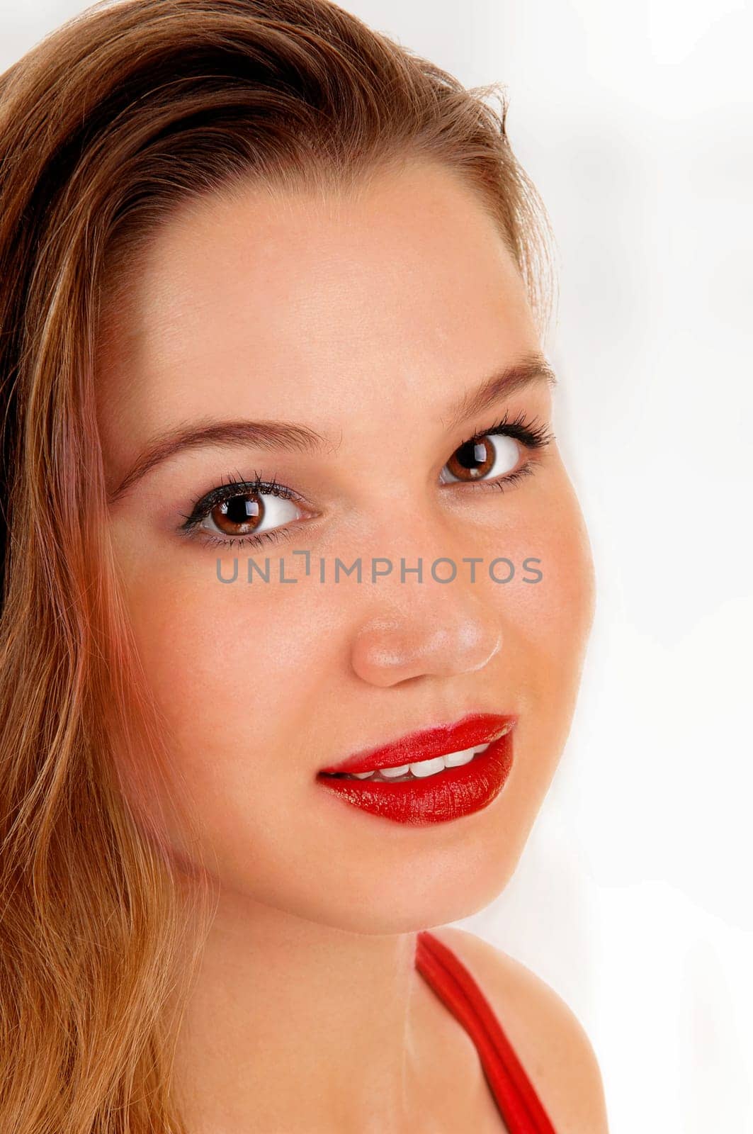 A closeup picture of a beautiful young woman with her red lips, looking.into the camera, isolated for white background..