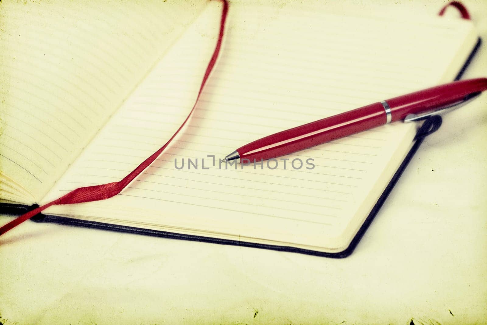 Vintage photo of blank notebook and pen