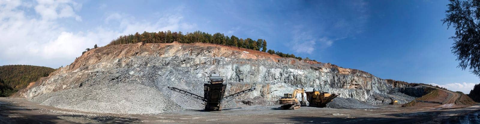 Panoramic view of stone quarry with machinery