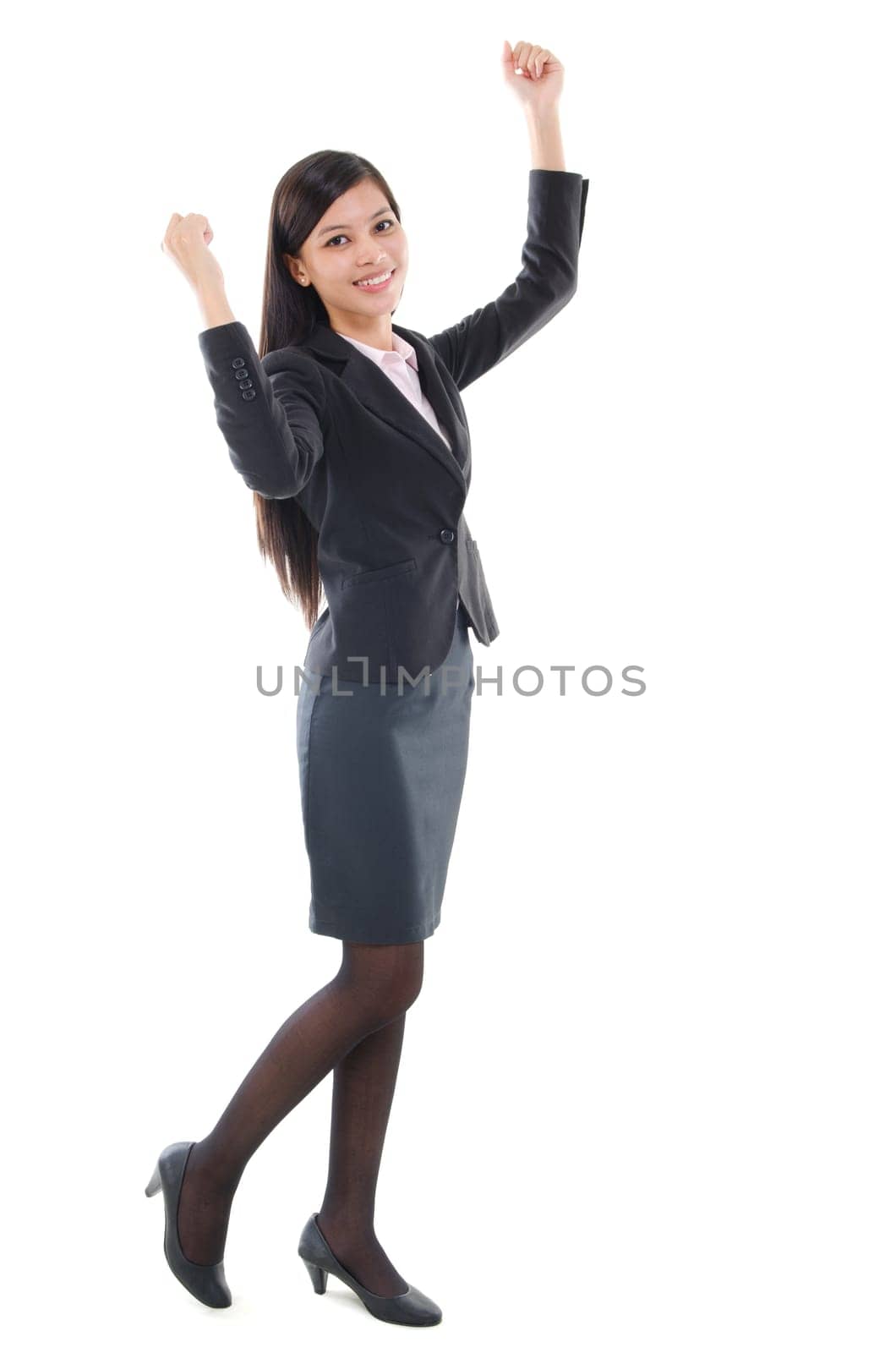 Portrait of pan Asian business woman in formal suit cheering, full length isolated on white background.