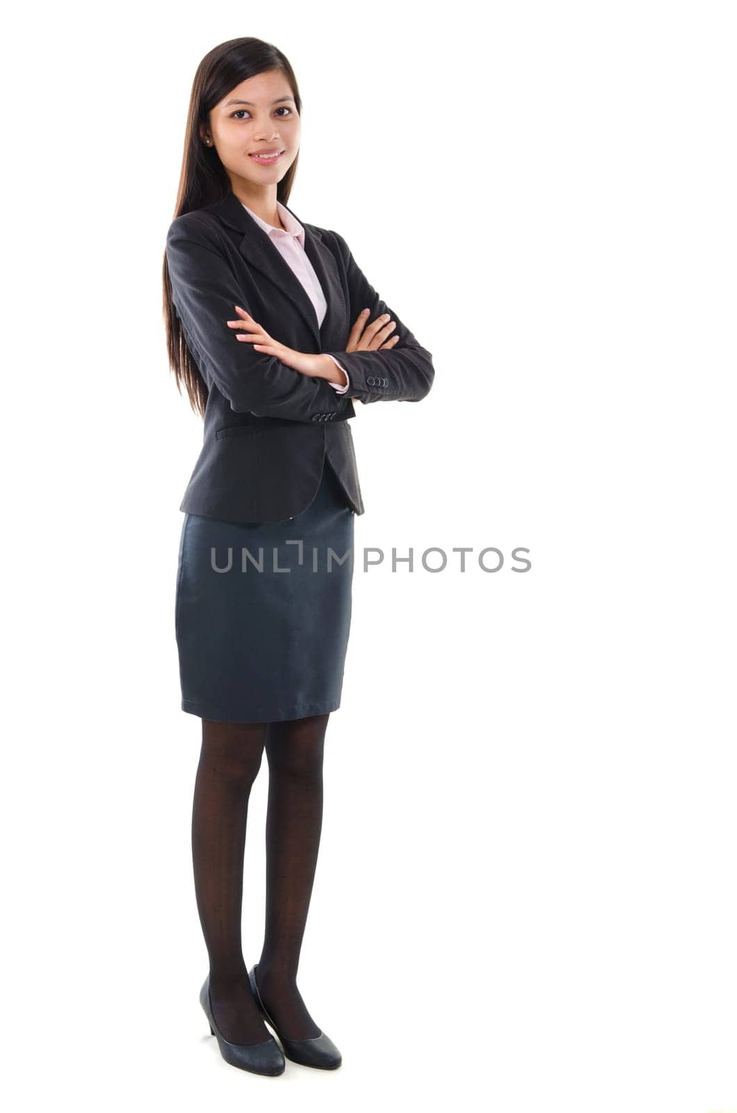 Portrait of pan Asian business woman smiling, full length standing isolated on white background.