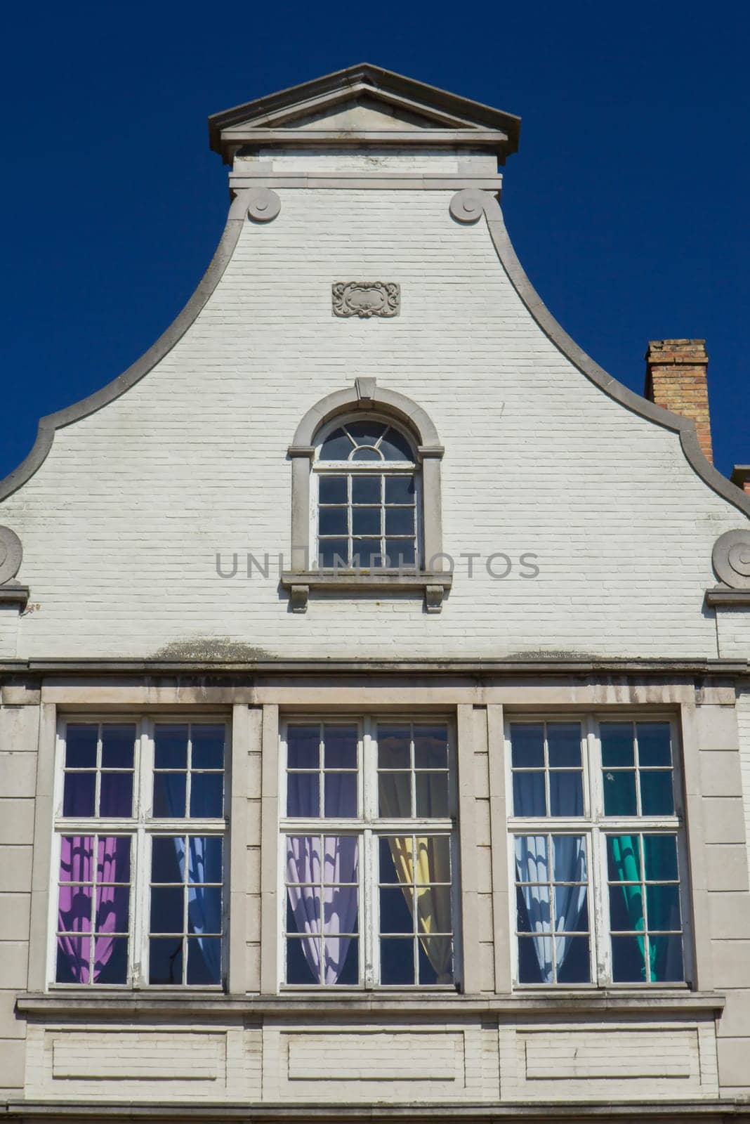 White gable roof of the historic house (Bruges, Belgium). Front view.