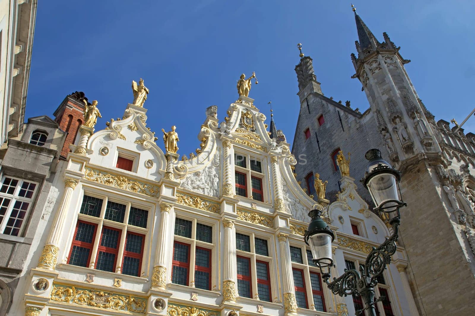 The Burg square in Bruges (Belgium). The Old Civil Registry in renaissance style. A street lamp in the foreground.