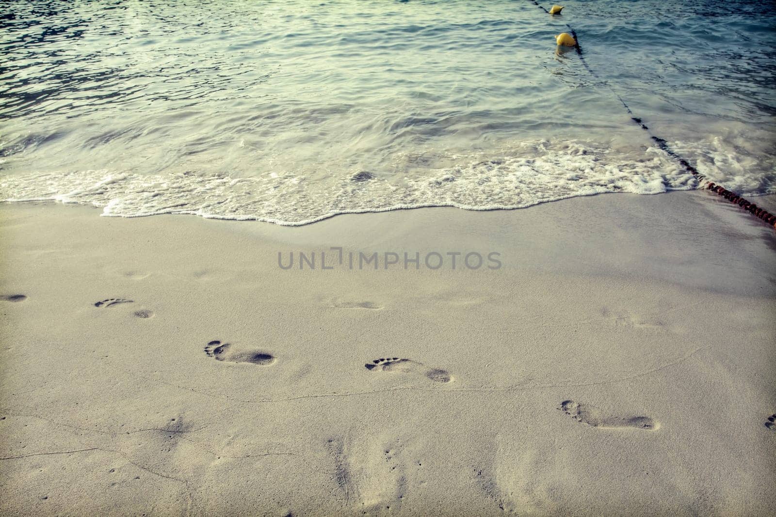 Footsteps in the sand on the beach