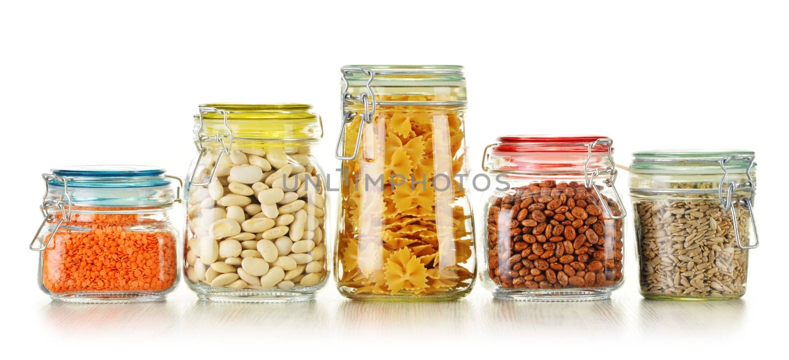 Jars with grain foods isolated on white background