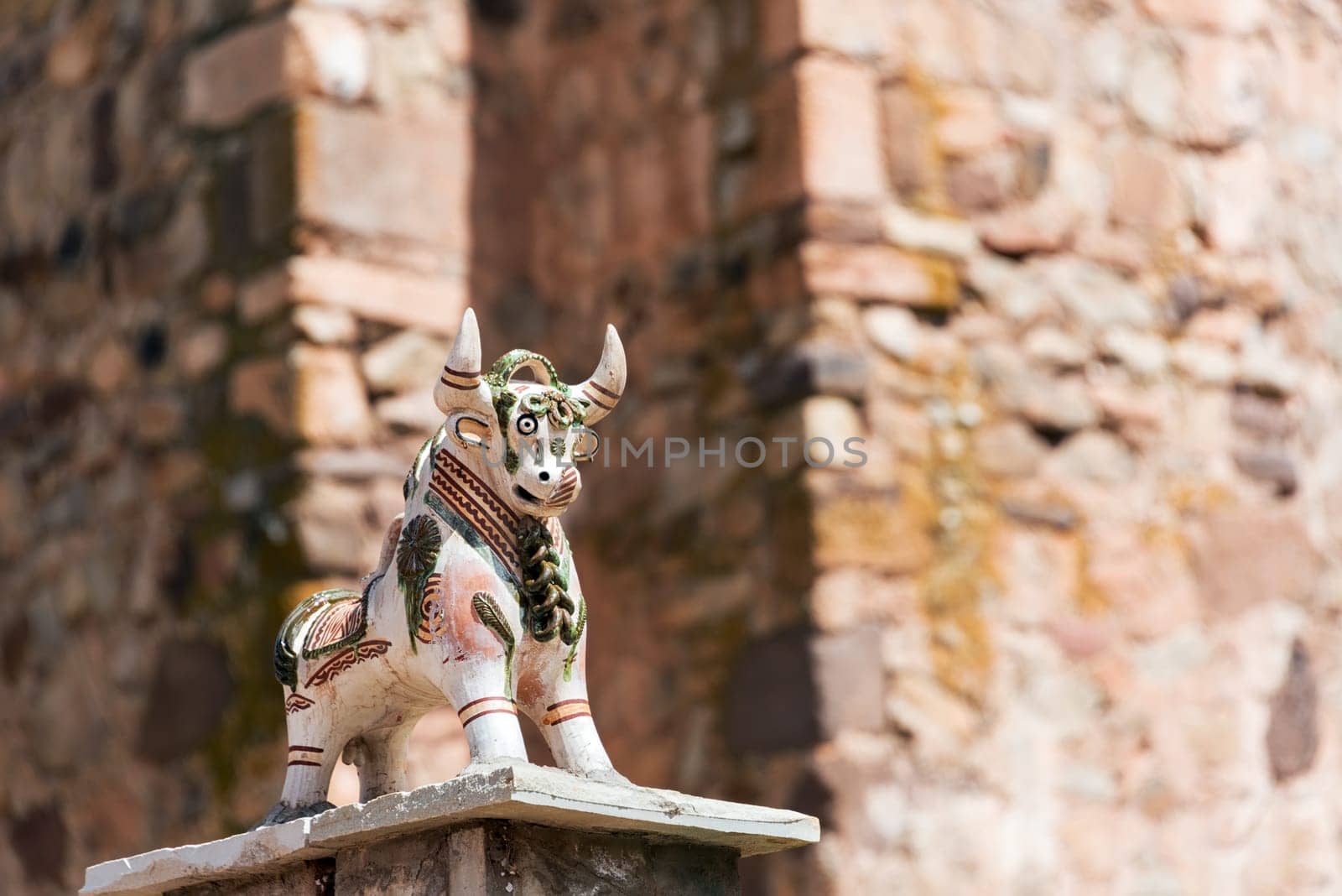 Small bull figurine on a church in Pucara, Peru near Cusco.  The bull is believed to protect buildings.