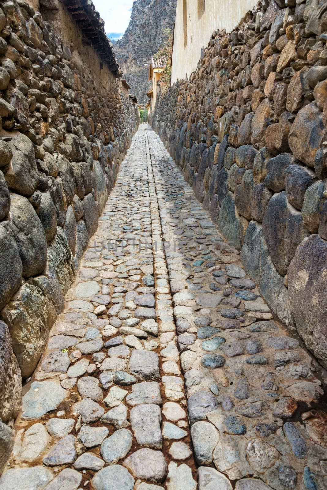 Narrow alley in the small historic town of Ollantaytambo in the Sacred Valley near Cusco, Peru