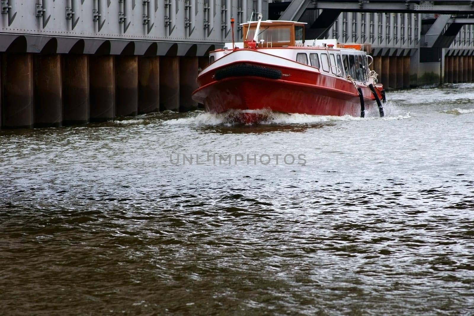 The photograph of a passenger boat for boat tours in the port canal of Hamburg.