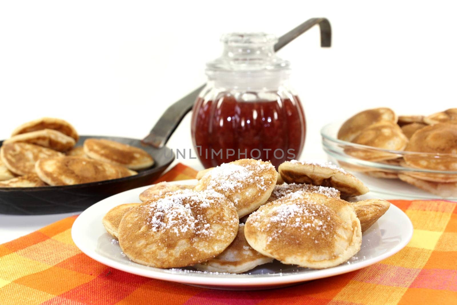 baked Poffertjes against a white background