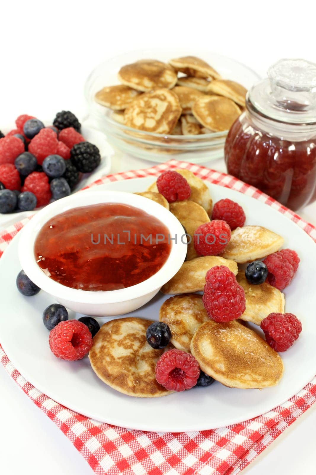baked poffertjes with raspberries and blueberries