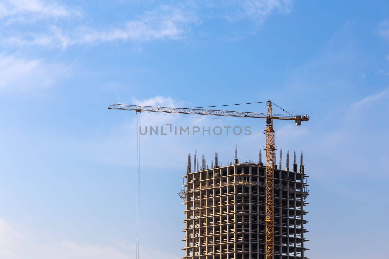 Construction crane on building site on sky background