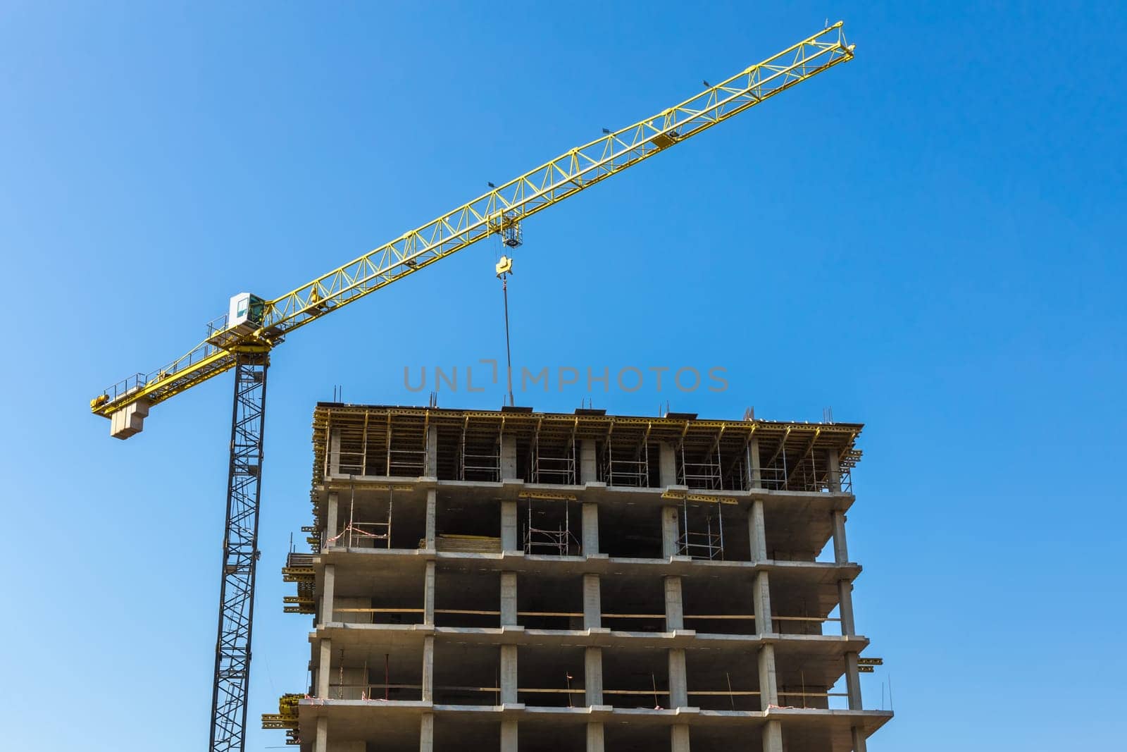 Construction crane on building site on sky background