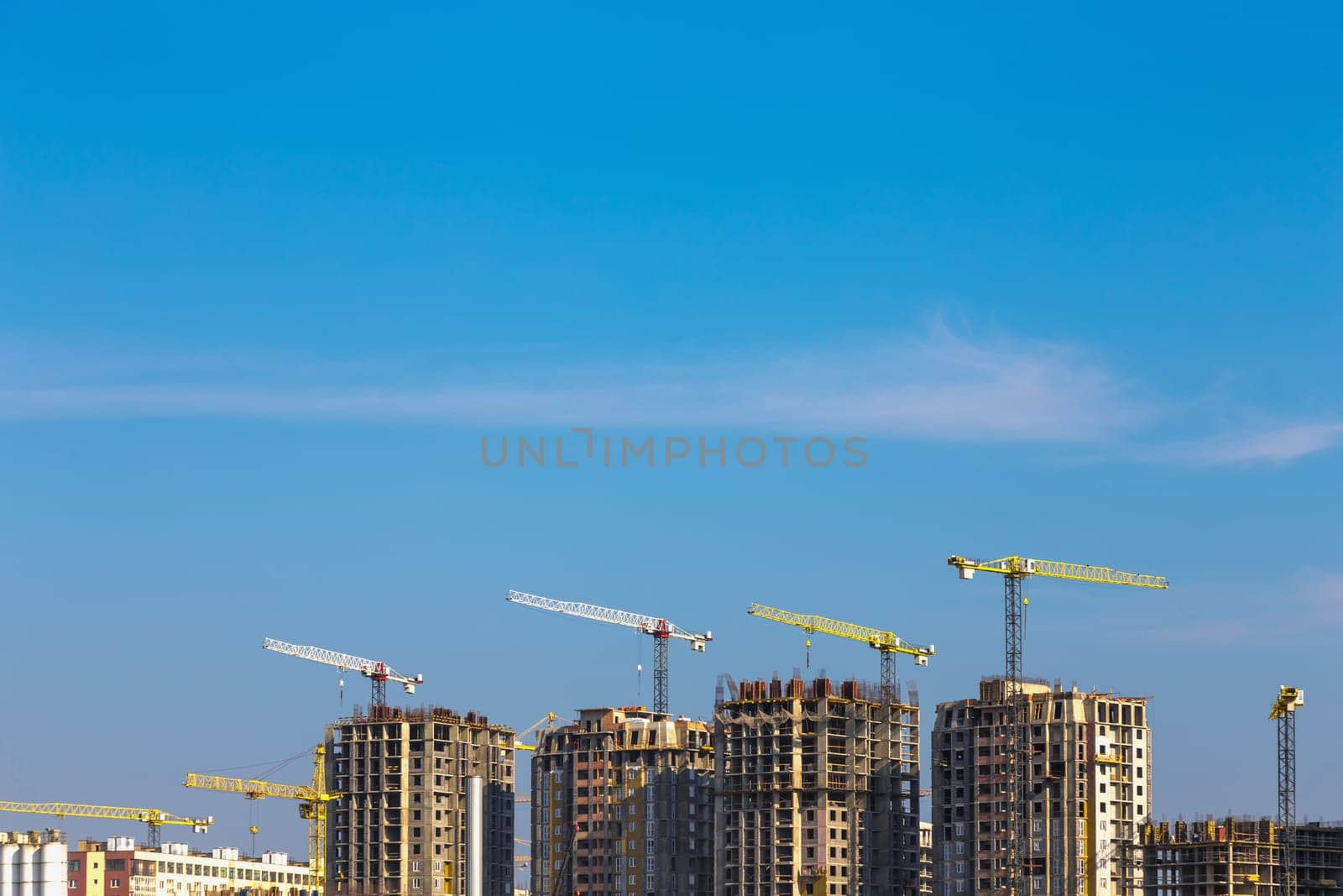 Building cranes on construction of city