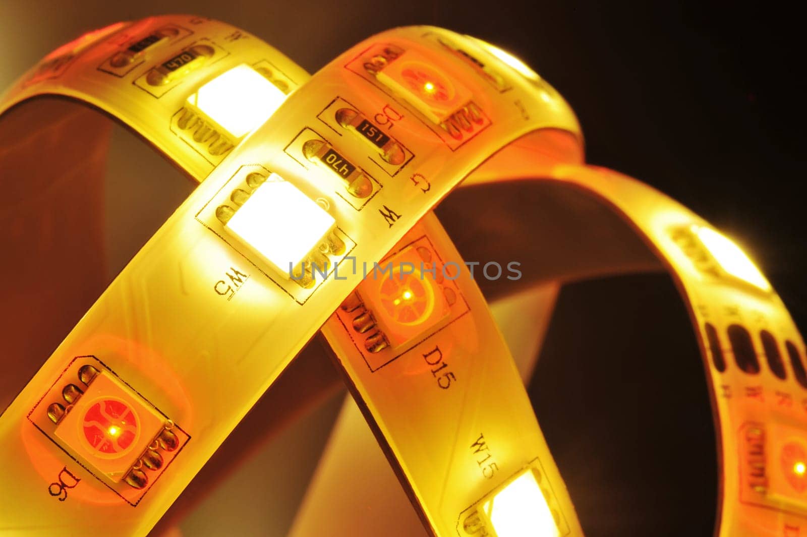 Macrodetail of an RGB LED strip combined with warm white LEDs in colored light