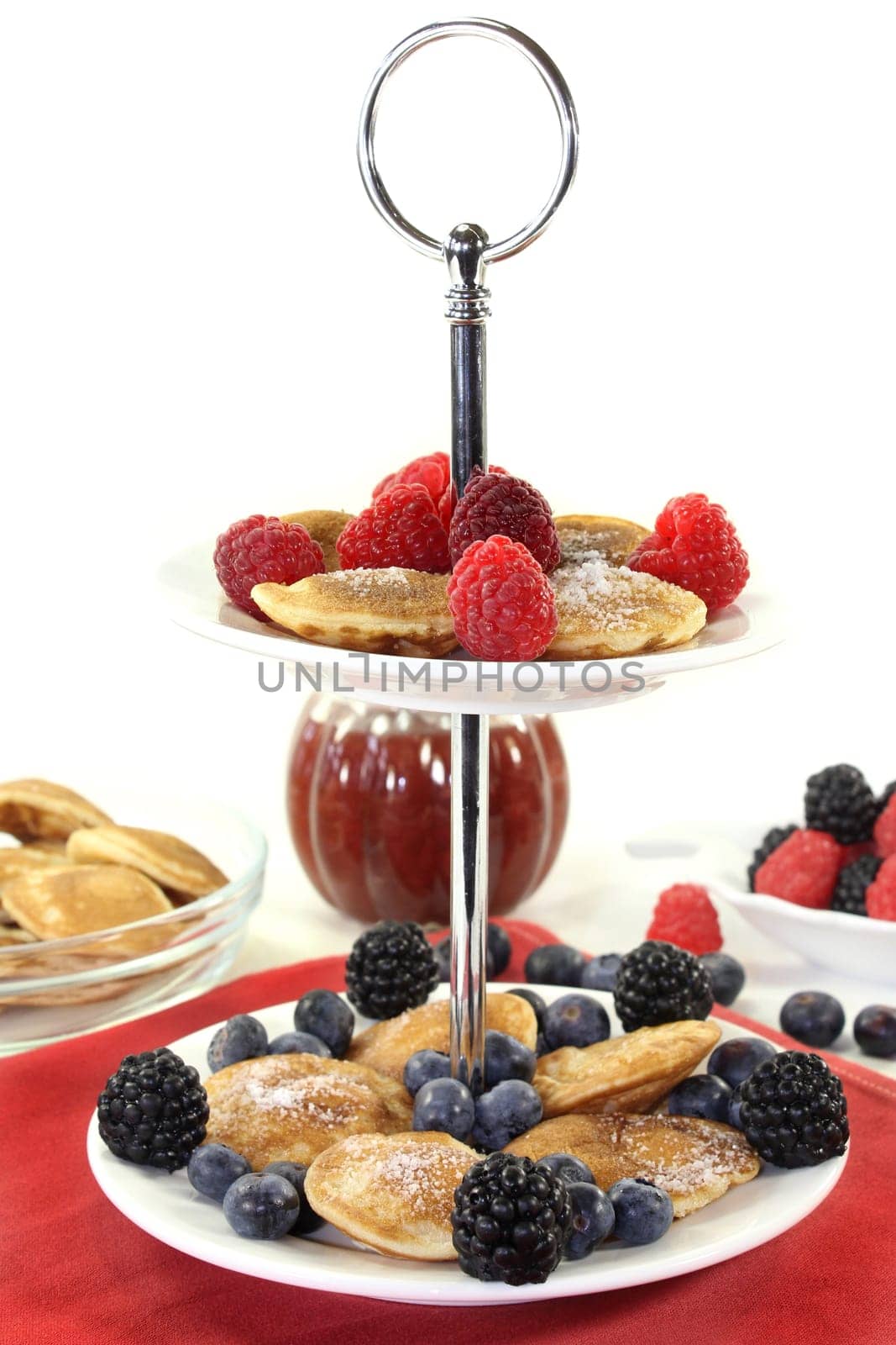 Poffertjes with raspberries and blueberries on one floor
