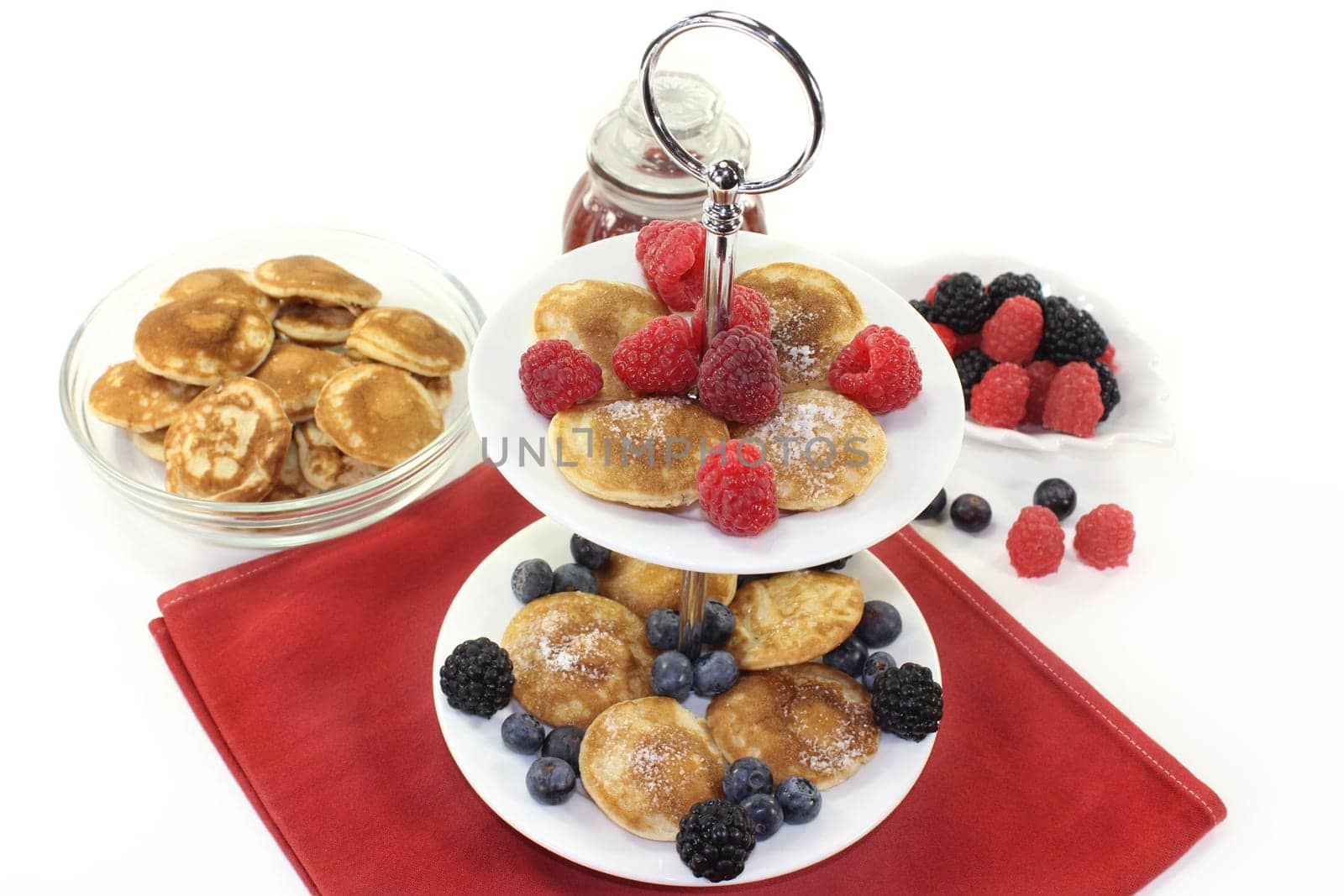 Poffertjes with raspberries and blueberries on one floor
