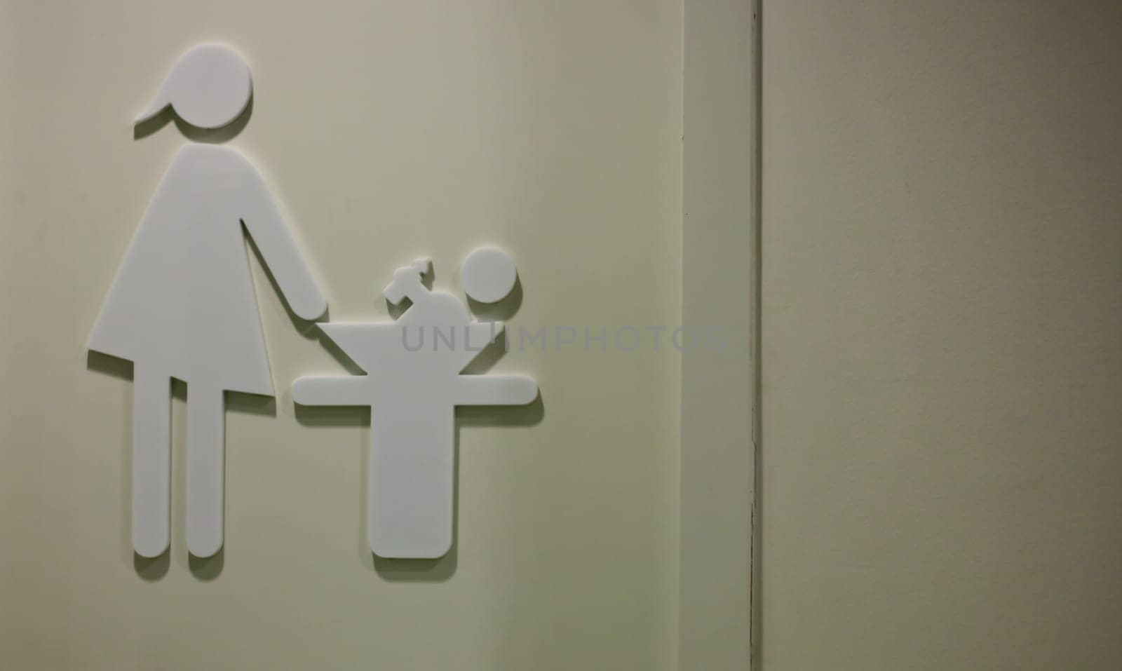 Door with pictogram of breastfeeding and changing room in a shopping center