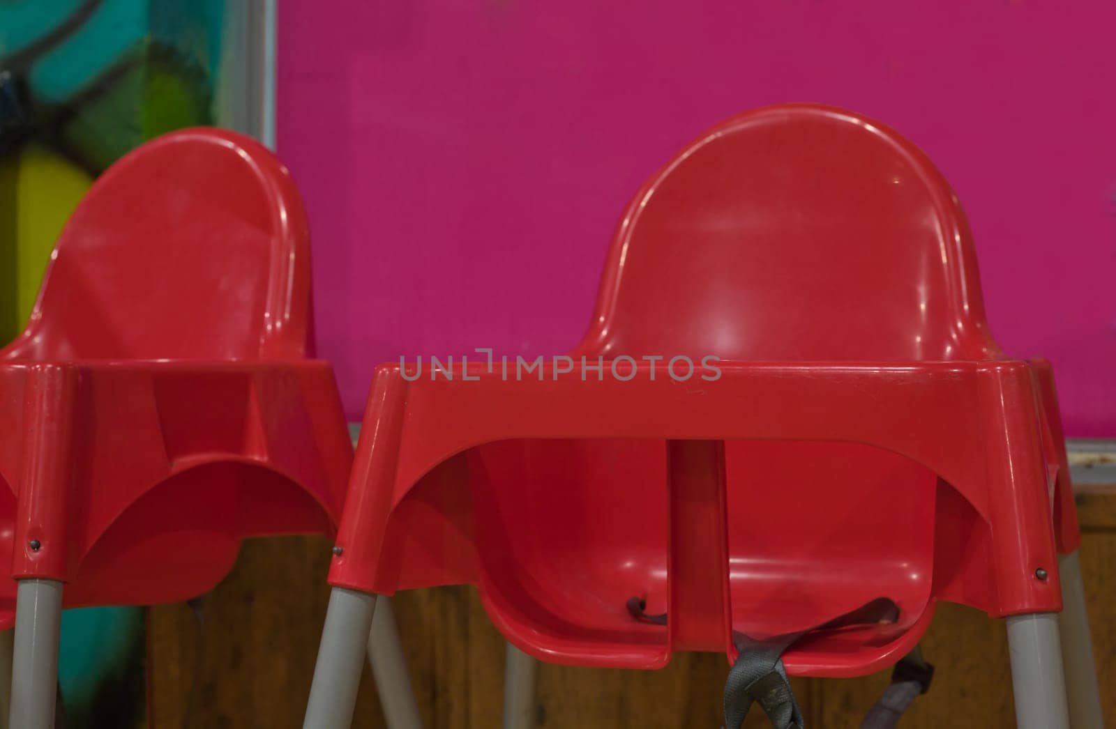 Red plastic dinning baby chairs with seat belts
