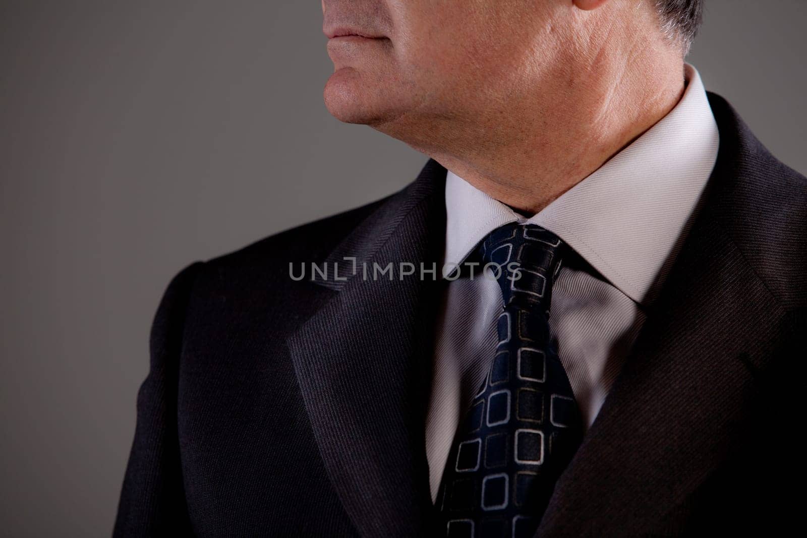 neck and a part of the face of an old man looking at his side