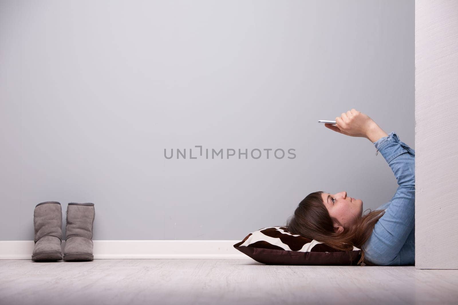 girl spending some time in relax lying down on the floor with her tablet