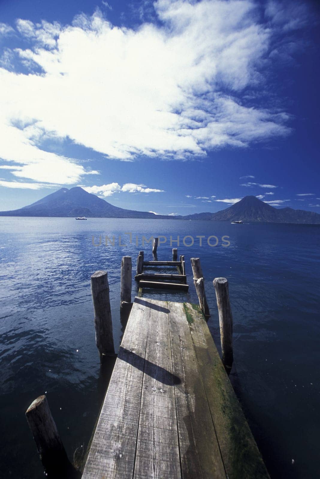 The Lake Atitlan with the Volcanos of Toliman and San Pedro in the back at the Town of Panajachel in Guatemala in Central America.