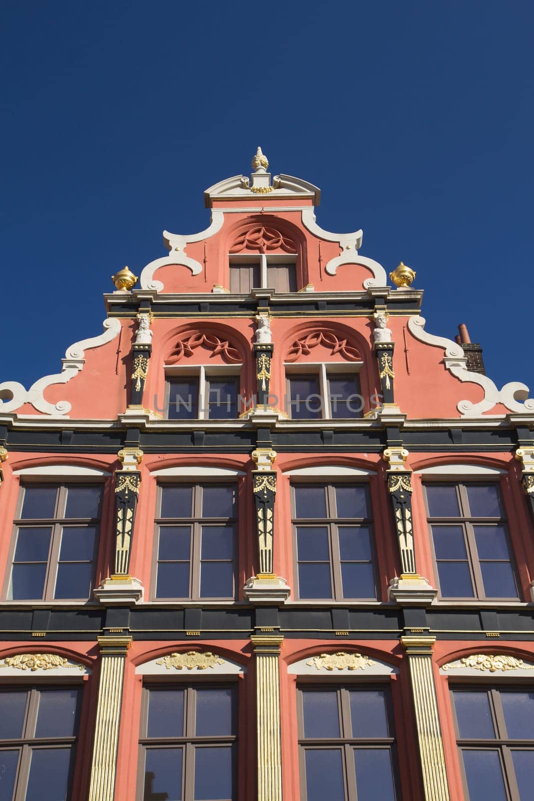 Gable roof and windows of the historic house (Bruges, Belgium). Front view.