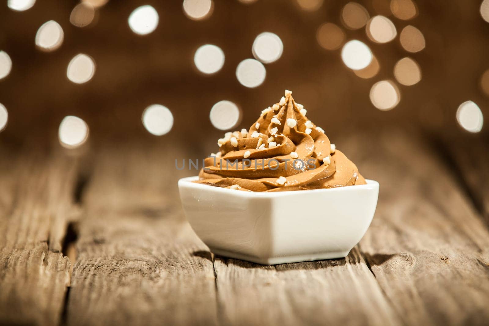 Macro Mouth Watering Brown Frozen Yogurt on Bowl Placed on Wooden Table