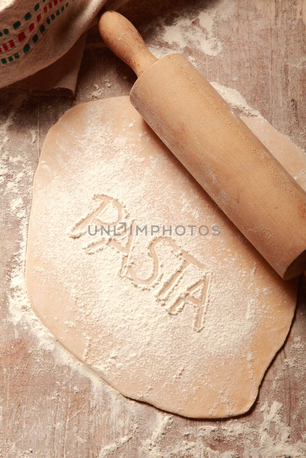 Homemade Flat Fresh Pasta Dough, Flattened by Wooden Roller, on Wooden Table