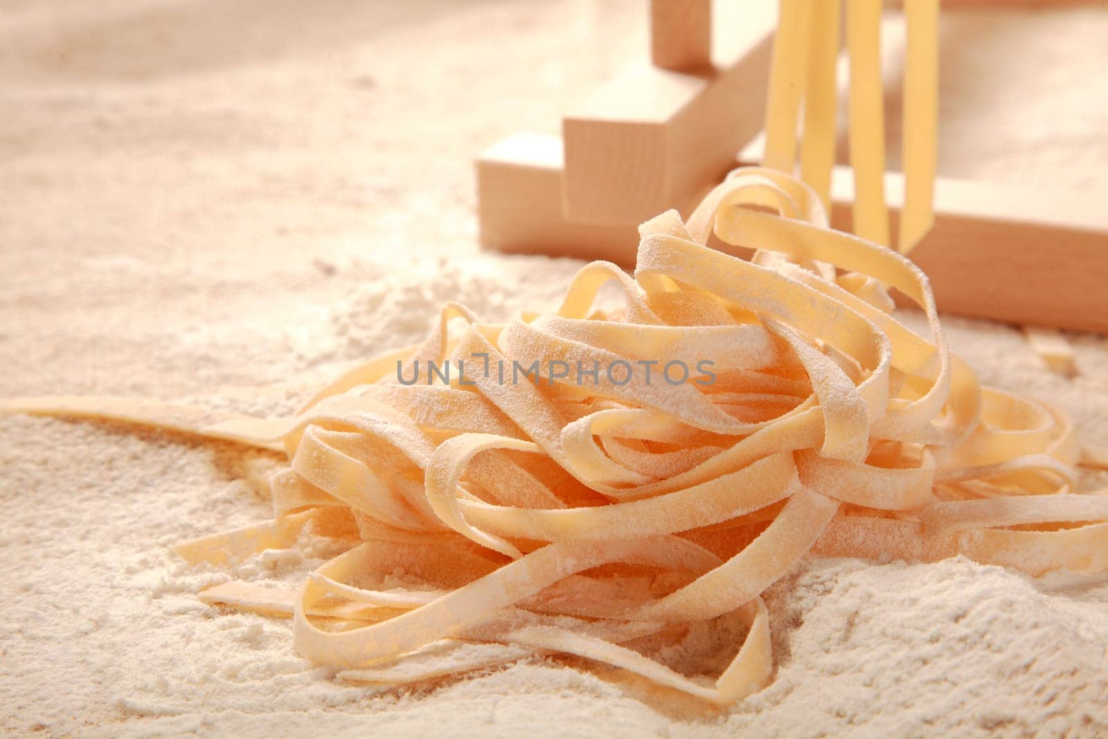 Close up Handmade Raw Fresh Italian Egg Pasta on Flour. Commonly Known as Fettuccine