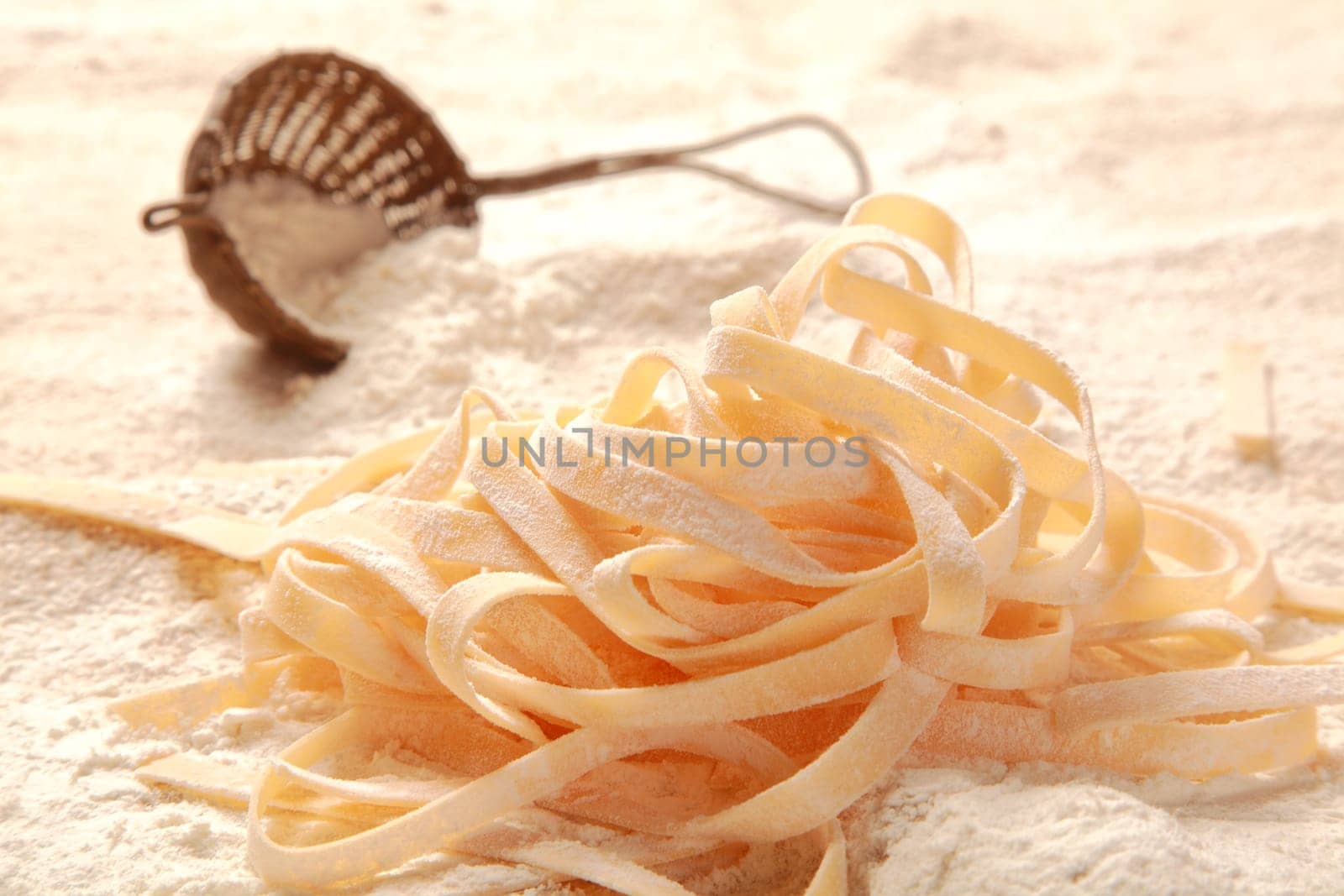Close up Homemade Fresh Egg Italian Pasta on Table Filled with Flour