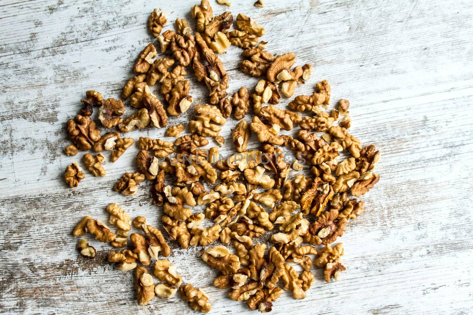 Many Walnuts over a wooden table, background.