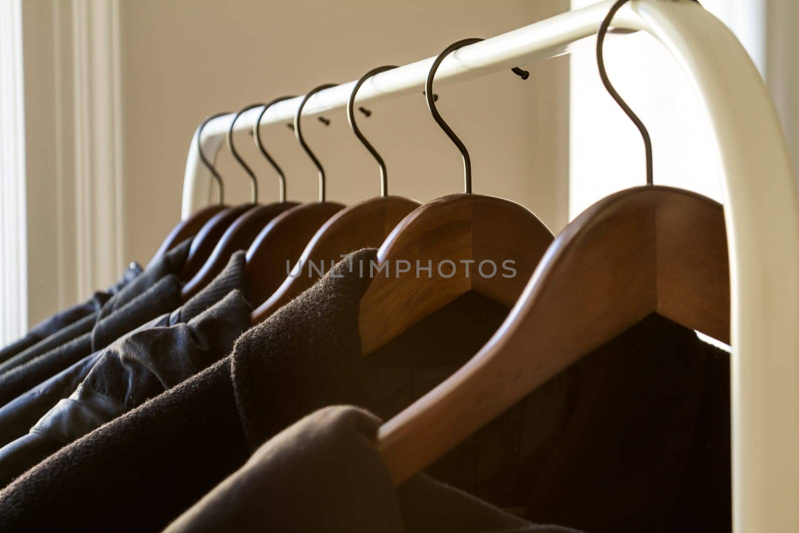 Winter clothes hanged on a clothes rack.