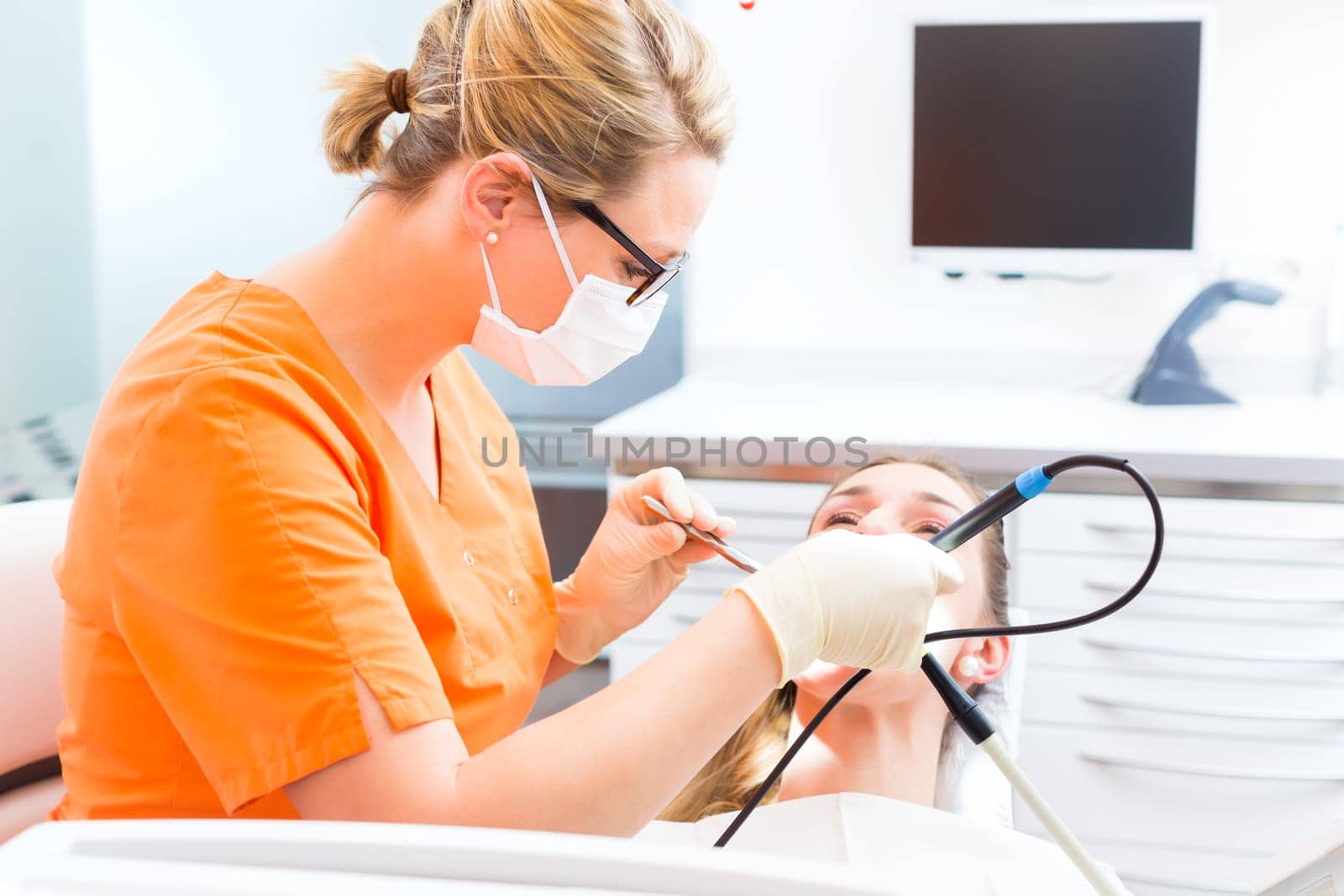 Patient has professional dental cleaning at the dentist