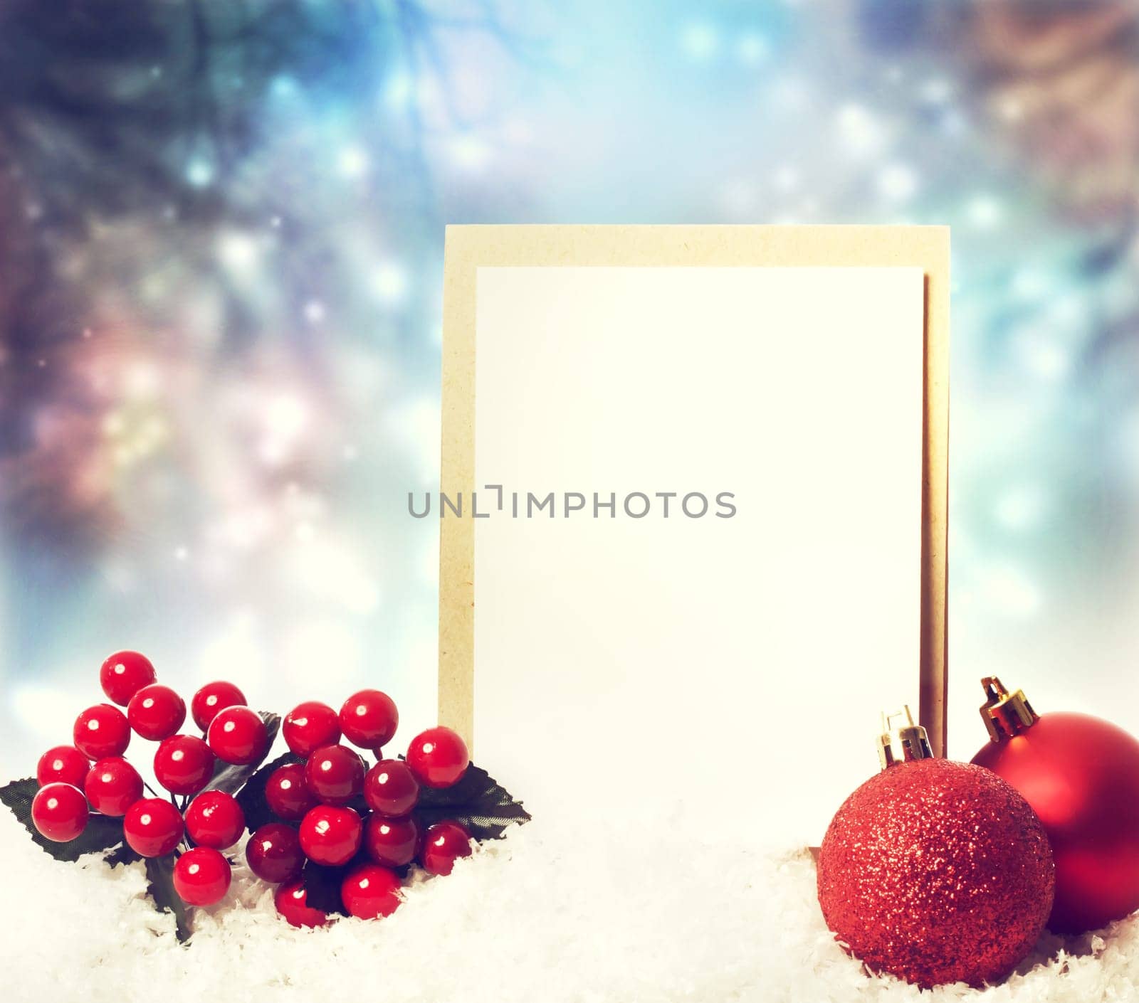 Christmas card with red ornaments on the snow