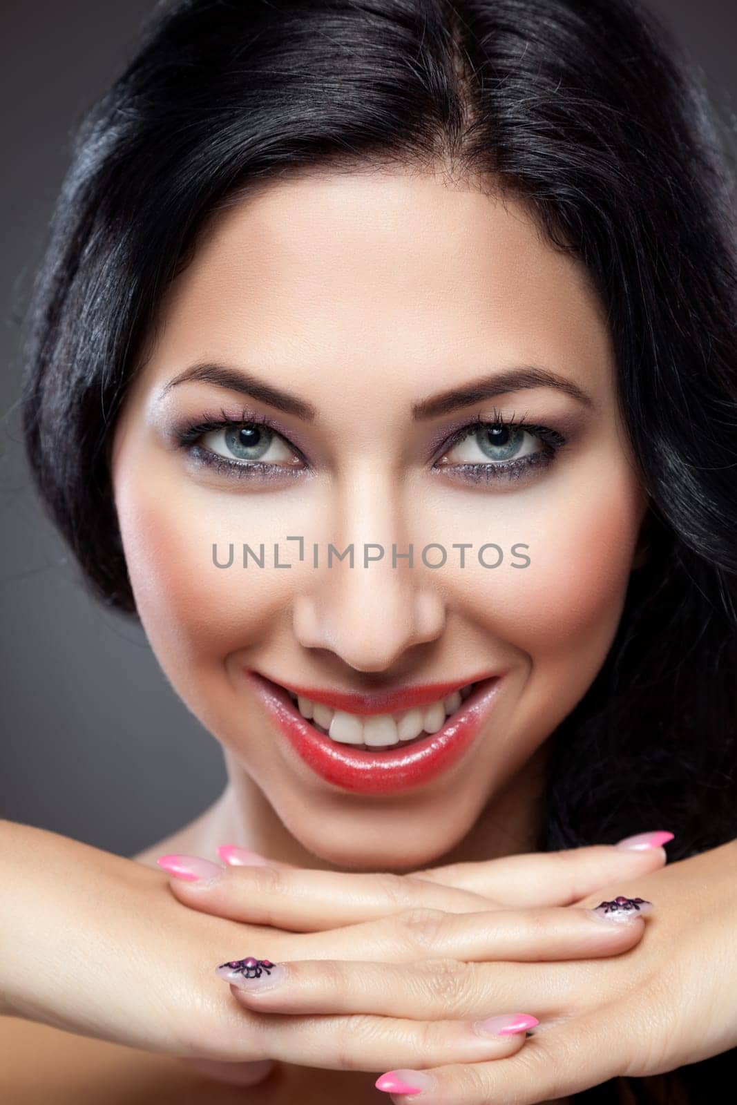 Young beautiful woman with perfect skin and nails