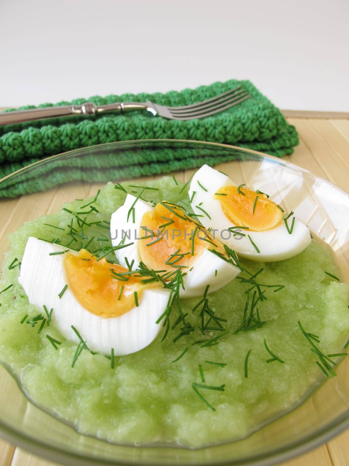 Eggs on cucumber puree with dill