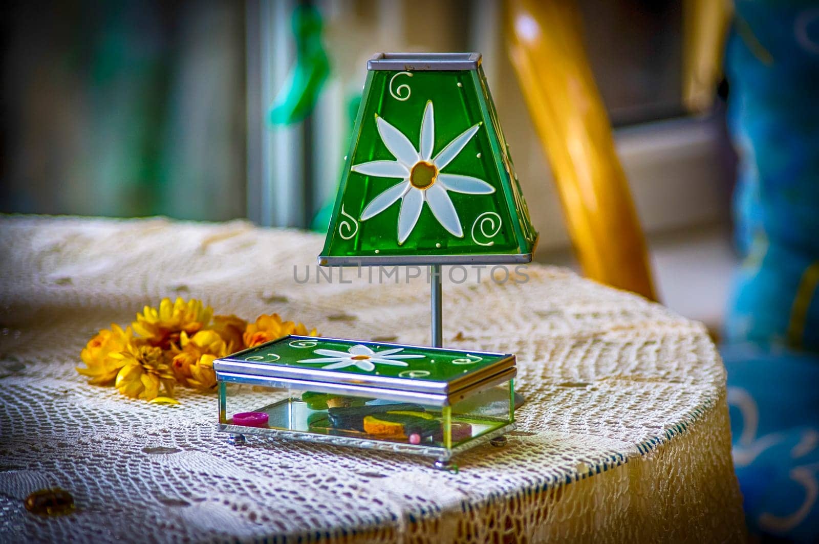 A small tiffany type lamp and casket on the table.